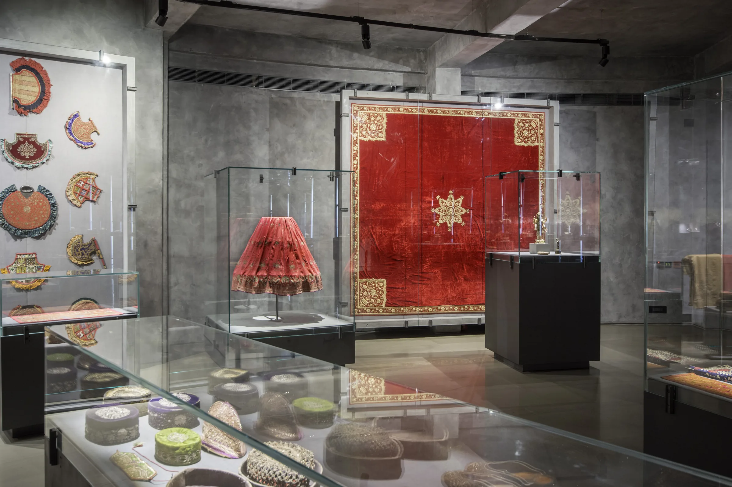 A red velvet hanging with a gold star, flanked by embroidered roundels.